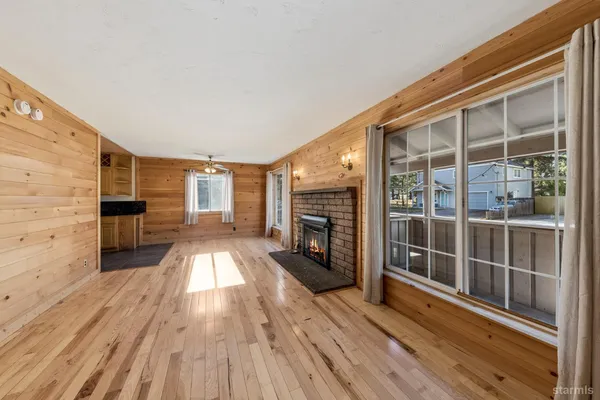 wooden floor in an empty room with a fireplace