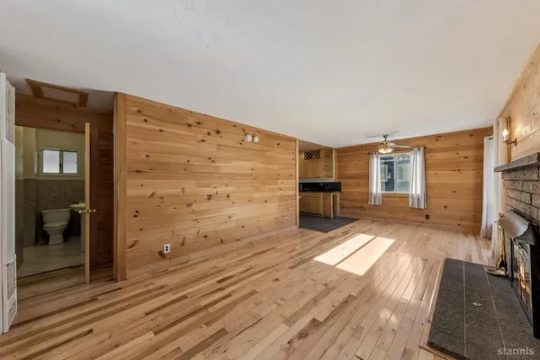 a view of a living room with furniture and wooden floor
