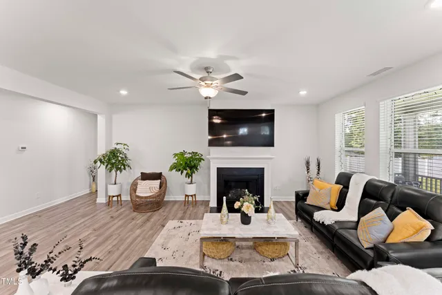 a living room with furniture fireplace and a window