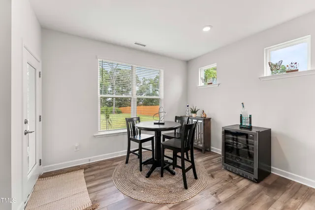 a view of a dining room with furniture and wooden floor
