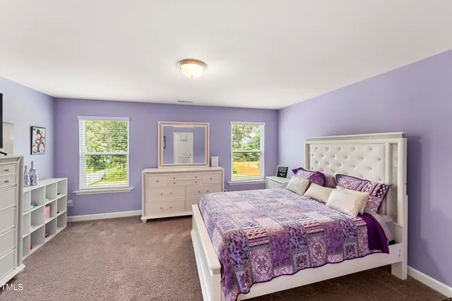 a bed room with a bed and a window