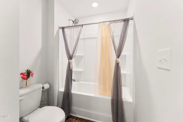 a white toilet sitting next to a bathroom sink