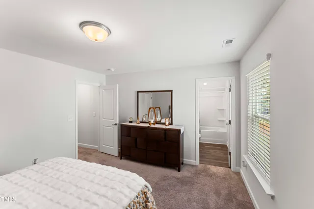 a bedroom with a bed and a dresser