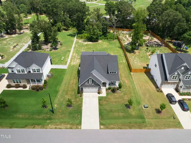 an aerial view of residential houses with outdoor space