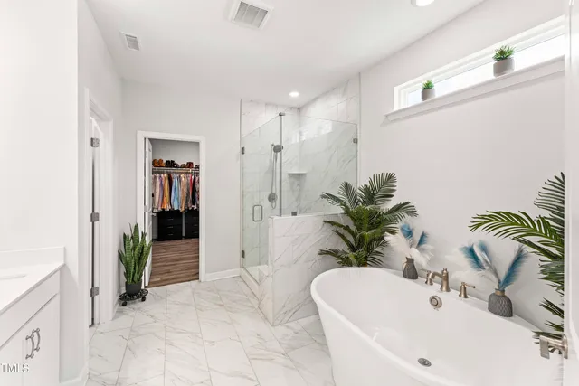 a bathroom with a granite countertop sink a large mirror and a shower