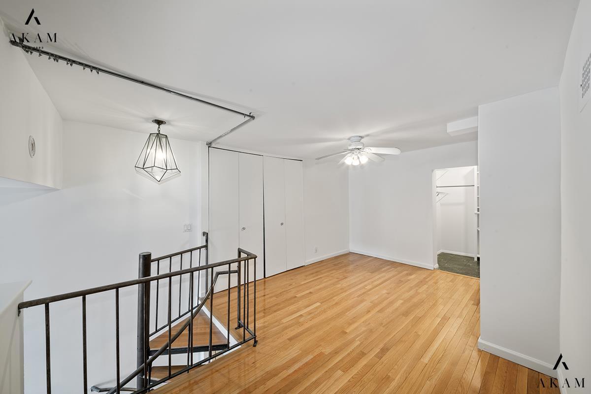 211 Thompson Street, Unit 4C Manhattan, NY 10012 - Photo 8 of 15 a view of empty room with wooden floor