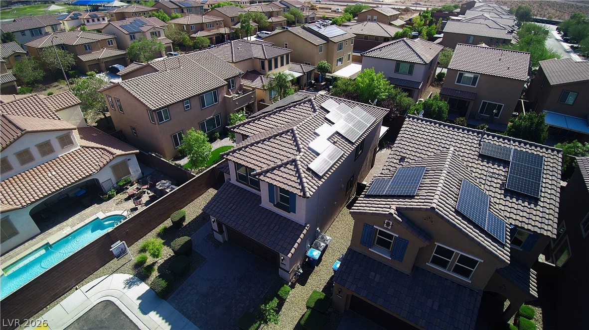 11045 Elk Sands Road Las Vegas, NV 89179 - Photo 62 of 67 An aerial perspective showcases a neat residential development with modern tiled roofs and solar panels.