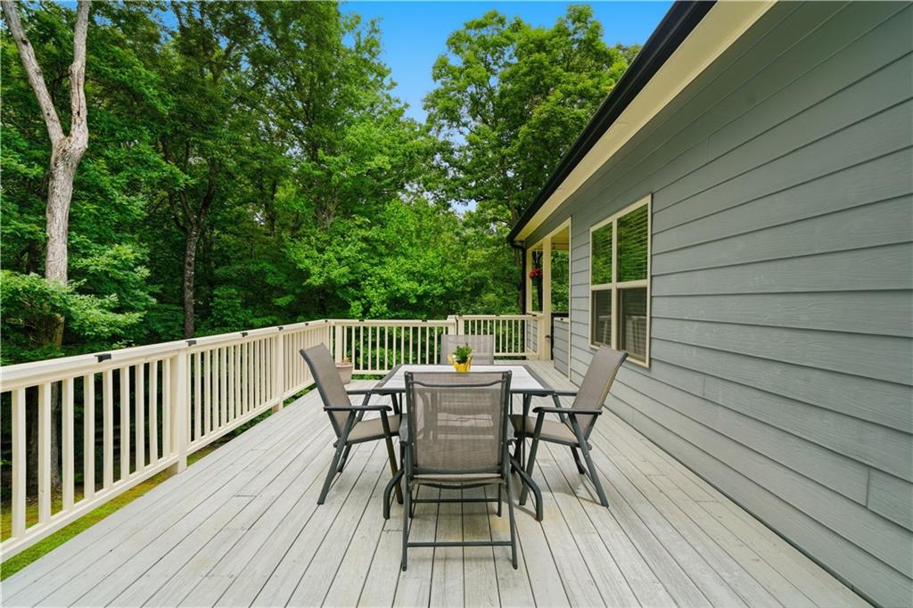 302 Spence Circle Ball Ground, GA 30107 - Photo 34 of 55 a view of a deck with table and chairs and wooden floor