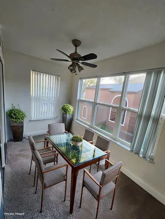 a dining room with furniture and window