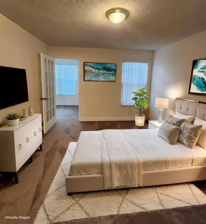 a bedroom with a bed and a flat screen tv