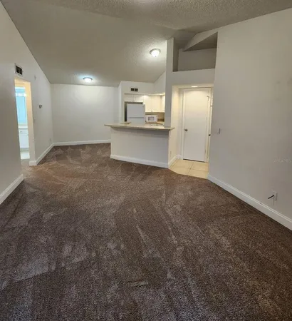 a view of a refrigerator in kitchen and wooden floor