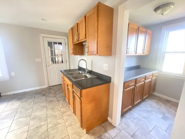 a kitchen with stainless steel appliances granite countertop a sink stove and cabinets