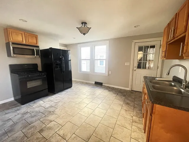 a kitchen with stainless steel appliances granite countertop a refrigerator and a sink