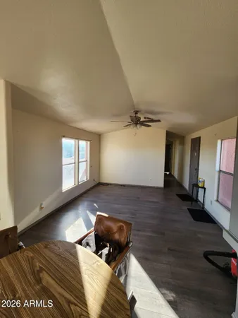 a view of a room with wooden floor and window