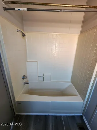 a bathroom with a tub and shower