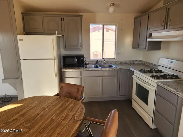 a kitchen with a stove a sink and a refrigerator