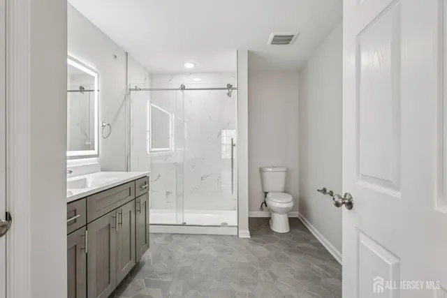 a view of empty room with wooden floor and fireplace