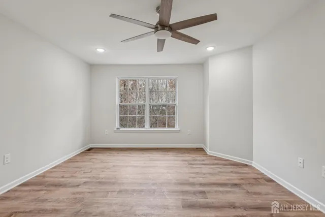 a bathroom with a granite countertop sink a mirror and a shower