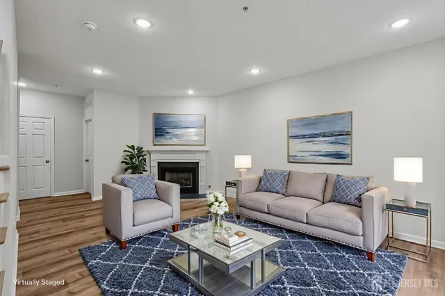a living room with furniture a fireplace and a table