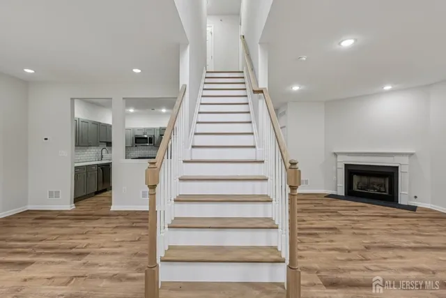 a view of a room with a chandelier fan and kitchen view