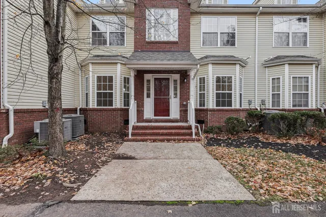 an empty room with wooden floor and ceiling fan