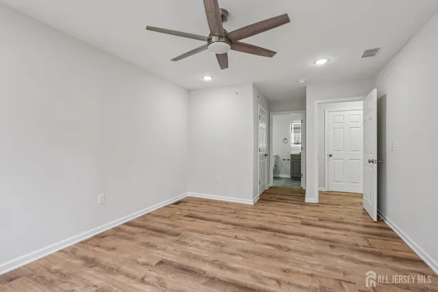 a view of walk in closet with empty racks