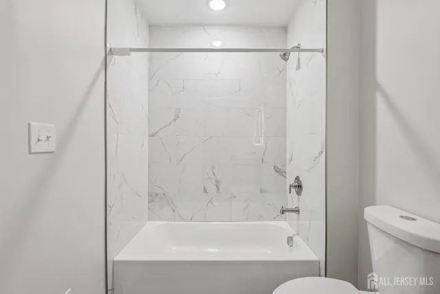 a bathroom with a sink toilet and mirror