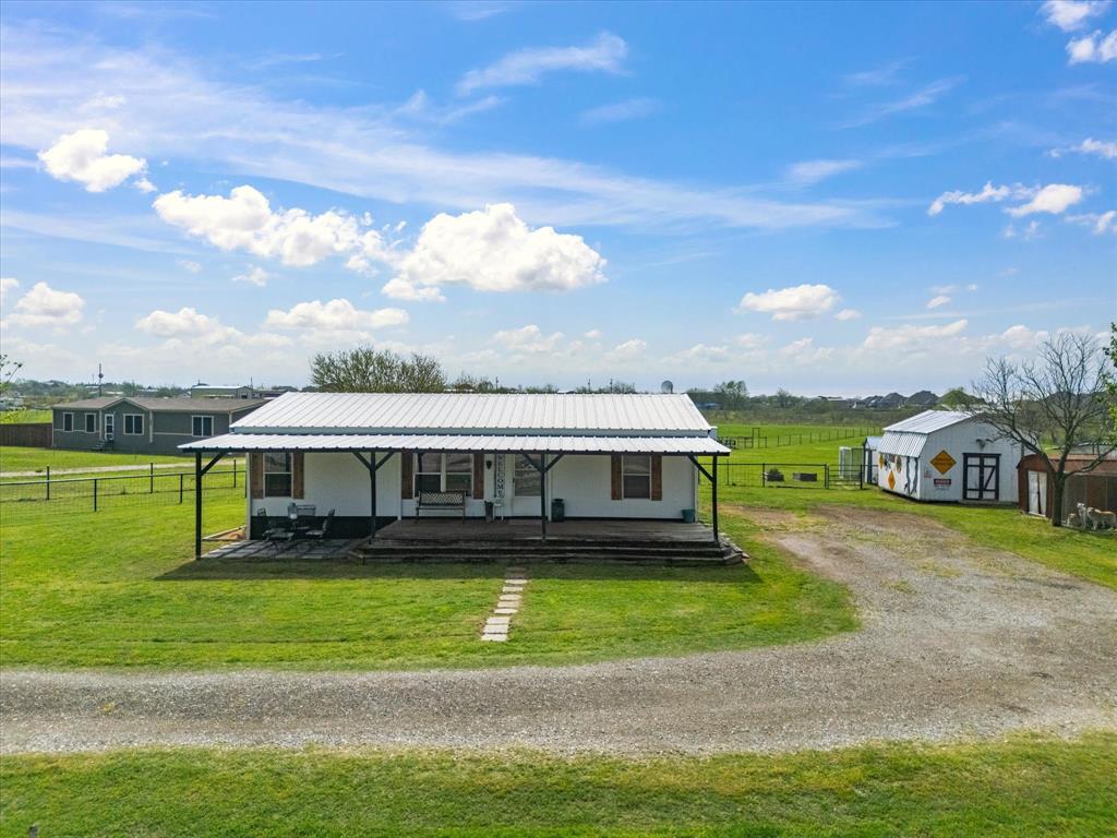 175 Back Forty Road Venus, TX 76084 - Photo 1 of 1 View of front of home featuring metal roof, fence, a rural view, a front yard, and driveway