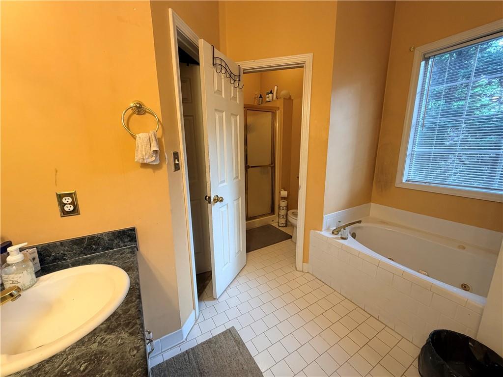 426 Pates Lake Court Hampton, GA 30228 - Photo 26 of 60 a bathroom with a granite countertop bathtub shower sink and toilet