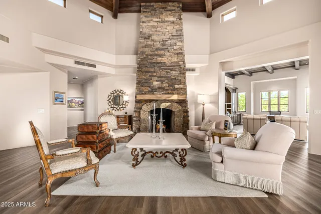 a living room with furniture large windows and a flat screen tv