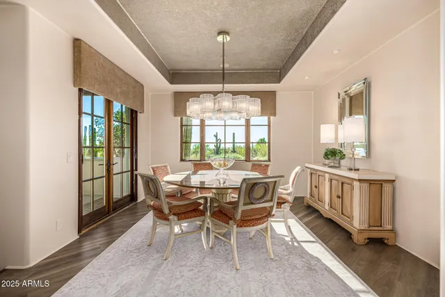 a bedroom with furniture and a large window