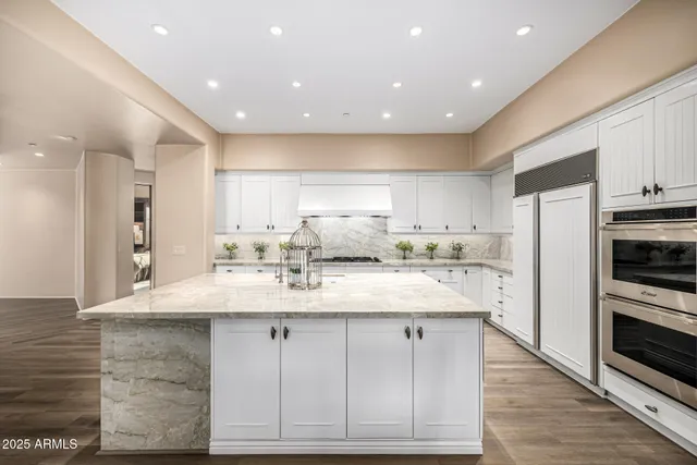a bathroom with a granite countertop shower and a mirror