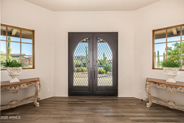 a kitchen with a sink stove cabinets and wooden floor