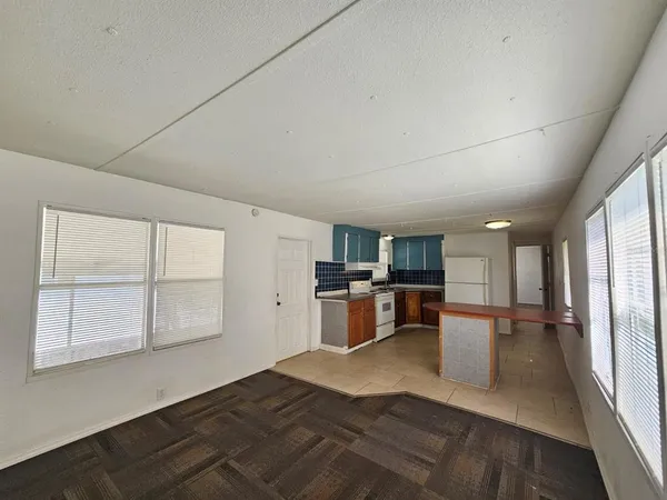 a kitchen with a refrigerator and window