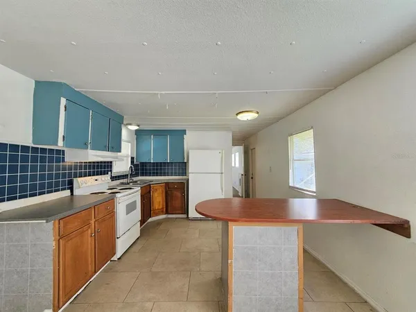 a kitchen with a sink cabinets and window