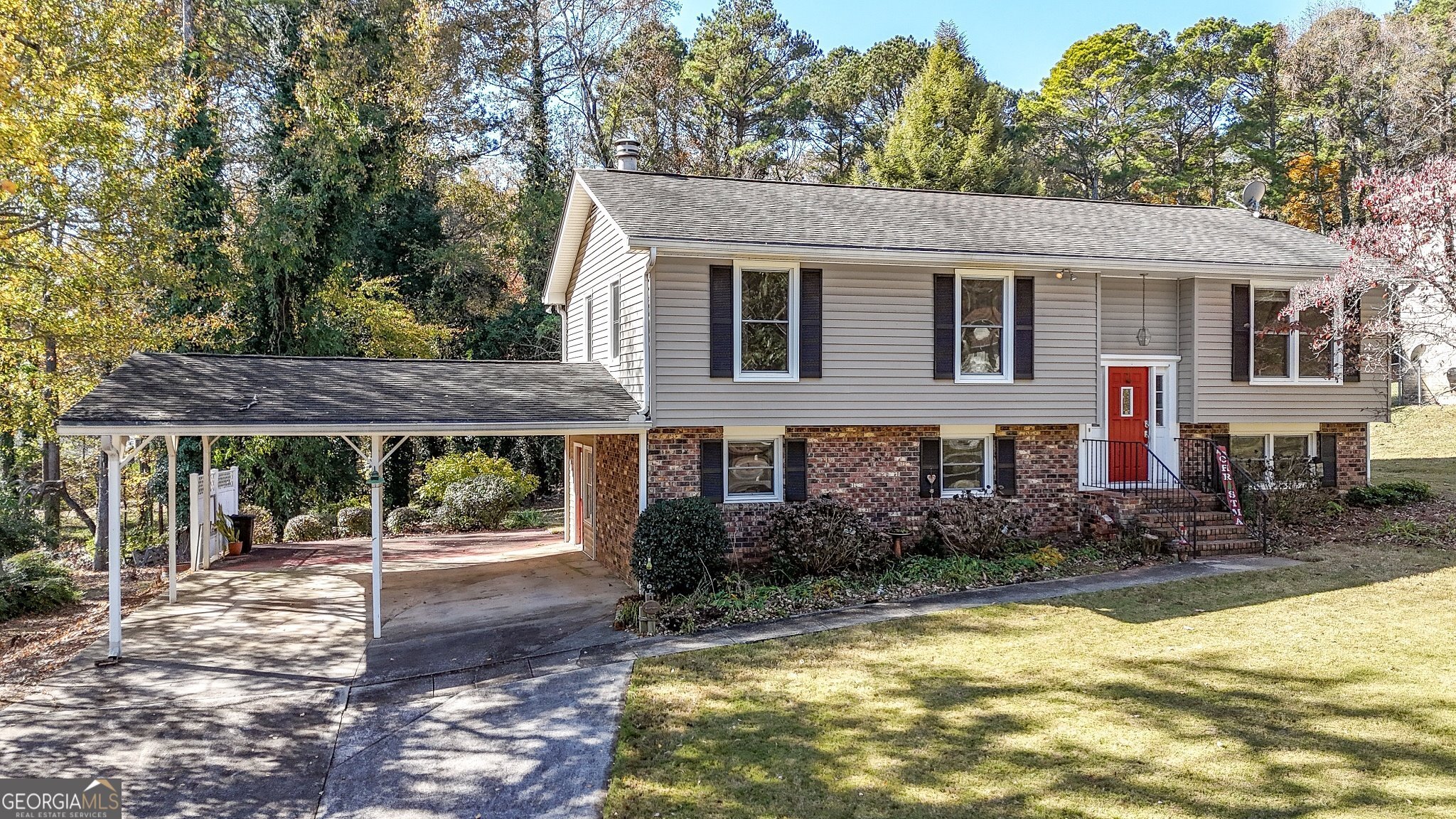 a front view of house with yard and trees around