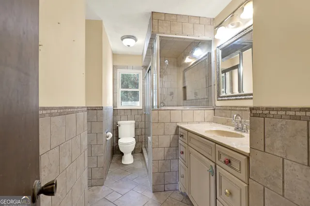 a view of an empty room with a window and a chandelier fan