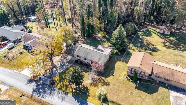 an aerial view of a house with a yard and garden
