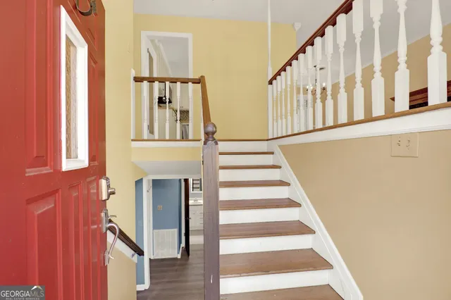 a view of entryway with wooden floor and windows