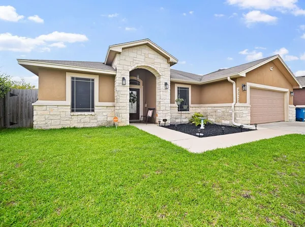 a front view of a house with a yard and garage
