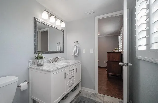 a dining room with furniture and a floor to ceiling window