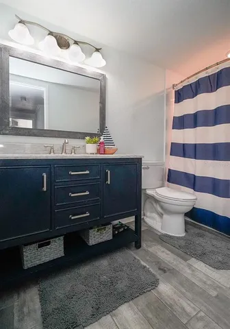 an aerial view of a house with a yard and lake view