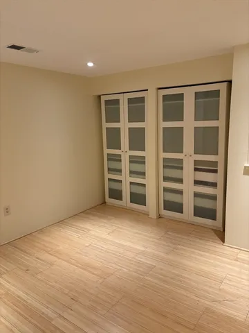 a view of wooden floor and windows in a room