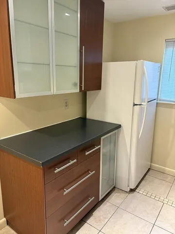 a kitchen with a refrigerator and a sink