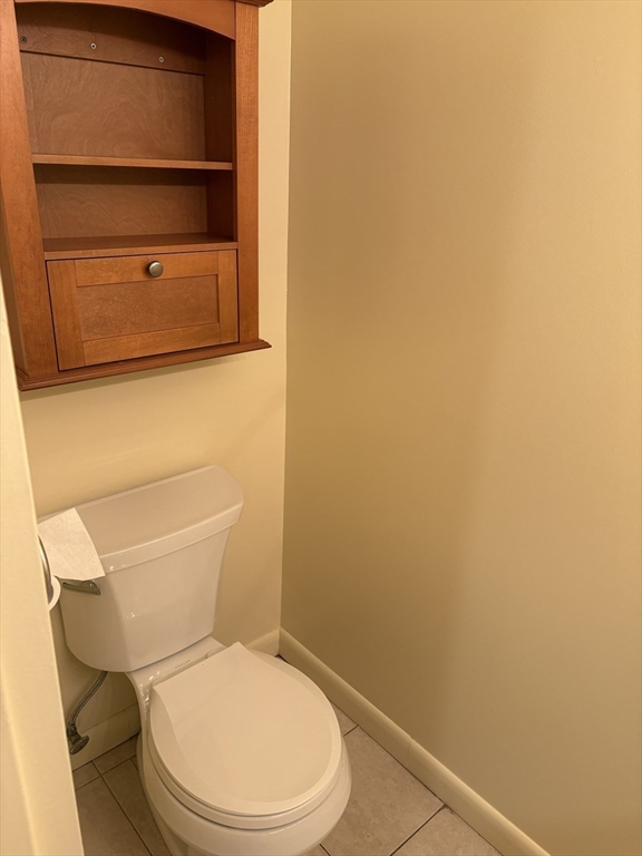24 Silver Hill Lane, Unit 24 Natick, MA 01760 - Photo 6 of 15 a white toilet sitting next to a shower