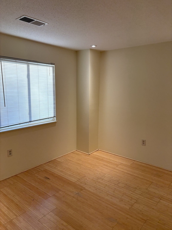 24 Silver Hill Lane, Unit 24 Natick, MA 01760 - Photo 8 of 15 an empty room with wooden floor and windows