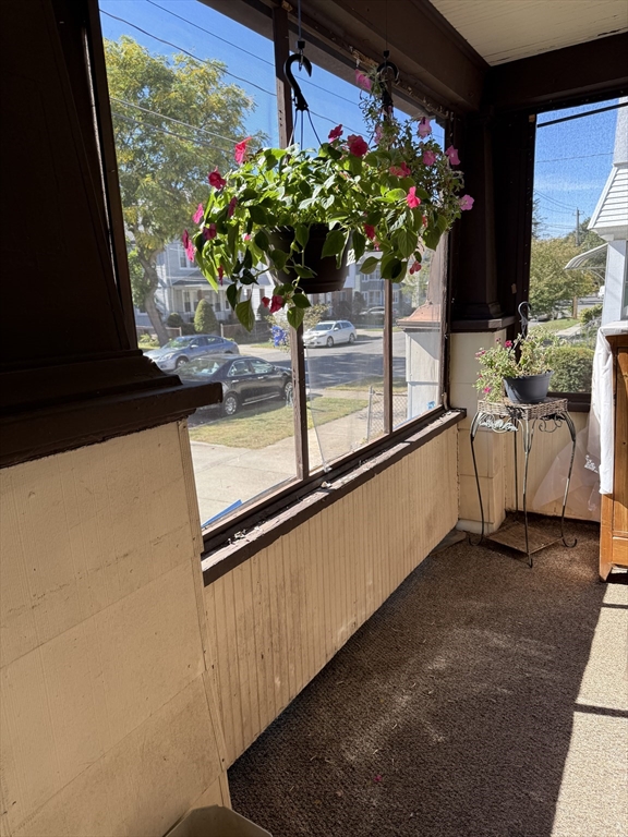 82-84 Maryland Street Springfield, MA 01108 - Photo 12 of 12 a vase of flowers sitting on a table with window