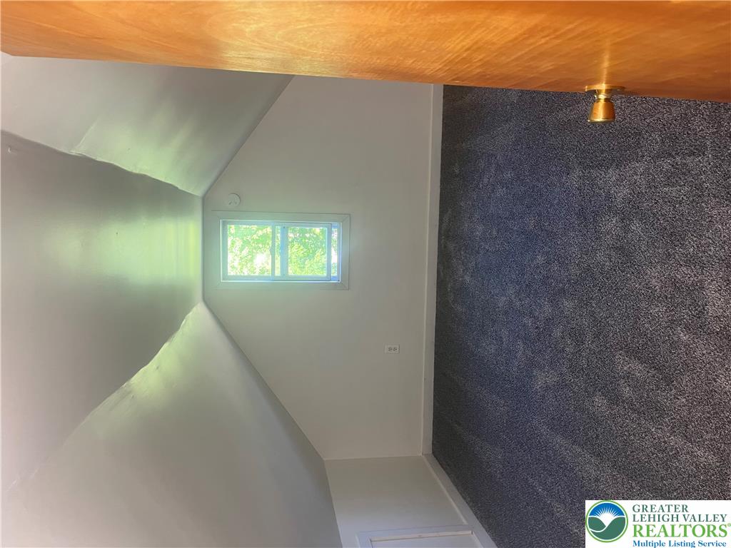 1839 Willow Park Road Bethlehem, PA 18020 - Photo 23 of 35 A cozy bedroom space boasts plush carpeting and an attic window for natural light.