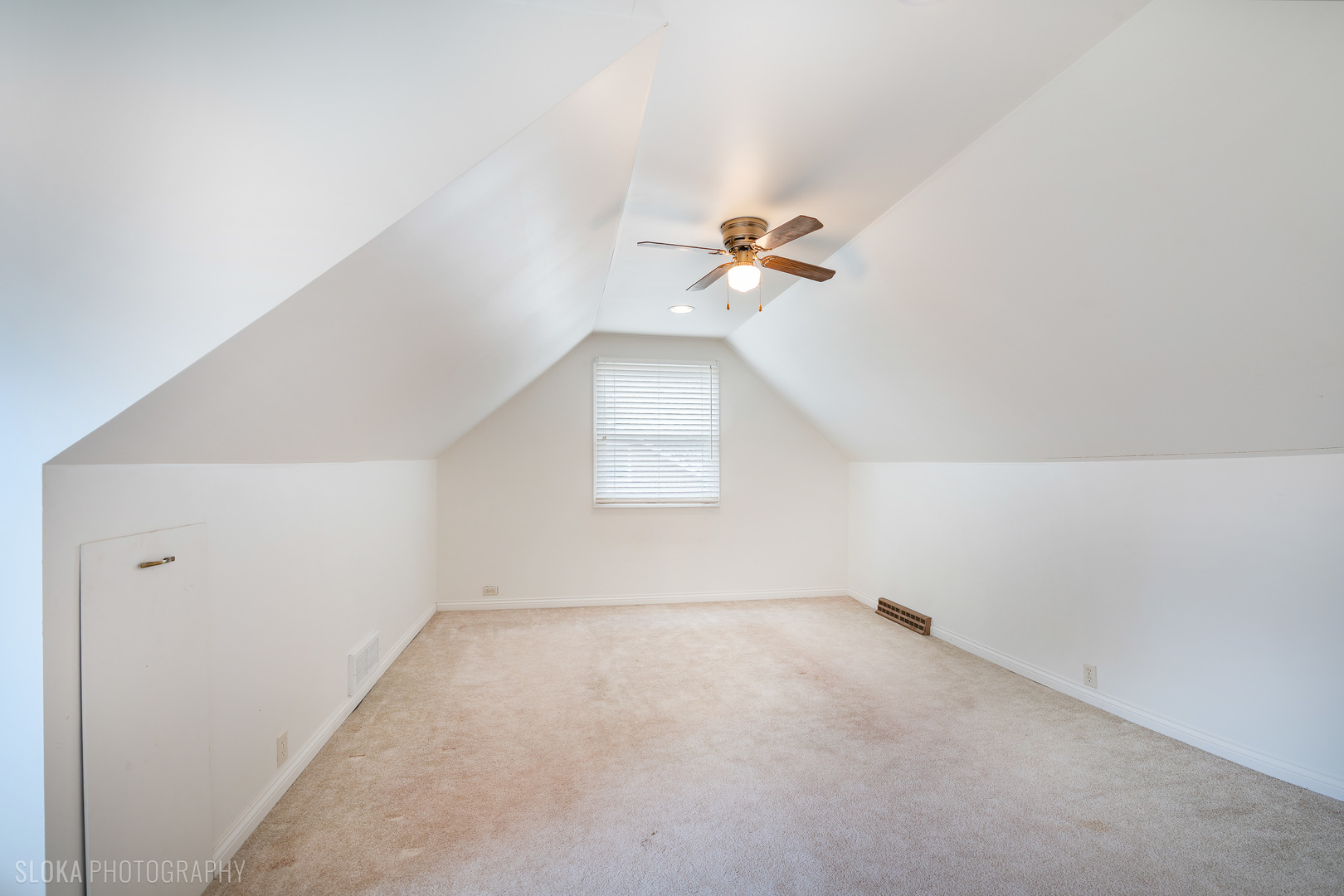 508 Crest Drive Cary, IL 60013 - Photo 16 of 35 an empty room with a chandelier fan and windows