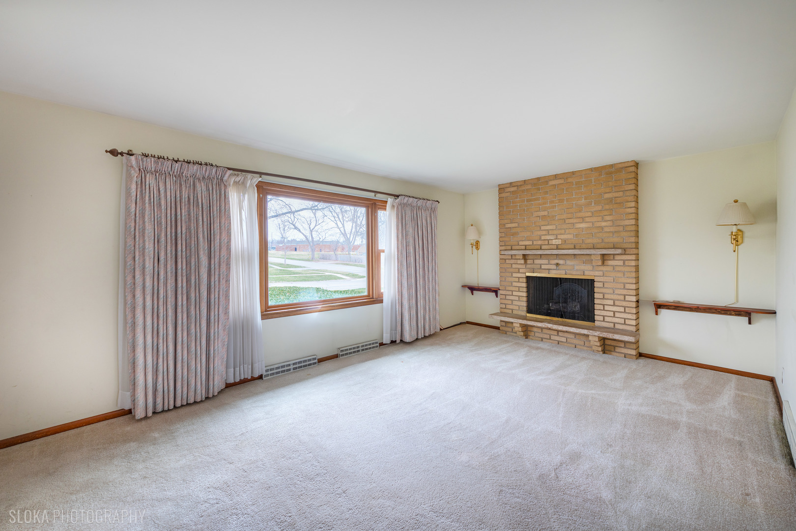 508 Crest Drive Cary, IL 60013 - Photo 4 of 35 an empty room with furniture and a fireplace